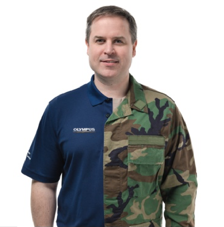 A man wearing a camouflage uniform on the right half side, and a Olympus polo shirt on the left half side.