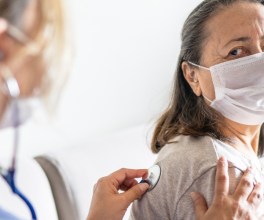 Physician checking patient's lungs