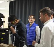 researcher looking through microscope