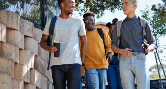 A group of students walking on the sidewalk